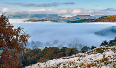 A cold and frosty autumn morning with frosted grass and a thick mist over Lake Bala / Llyn Tegid...