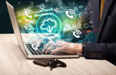 Business hand typing on a modern laptop