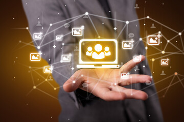 Hand holding social media icons