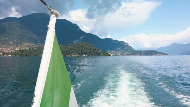 Clip of small waves on the Como lake, after a tourist ferry. The boat is sailing with tourists between the cities. It is a beautiful sunny summer day. Slow motion 4K