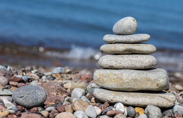 Pyramid of flat sea stones on the beach