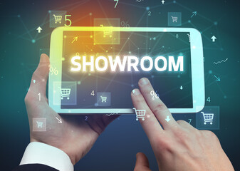 Close-up of a hand holding tablet with shopping inscription