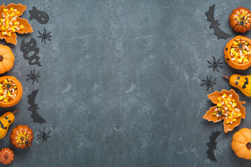 Halloween holiday background with jack o lantern pumpkin, candy corn and decorations