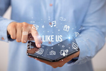 Businessman holding a foldable smartphone, social media concept