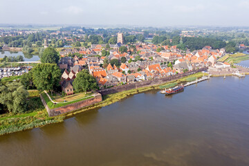 Fototapeta na wymiar Aerial from the city Woudrichem at the river Merwede in the Netherlands in a flooded landscape