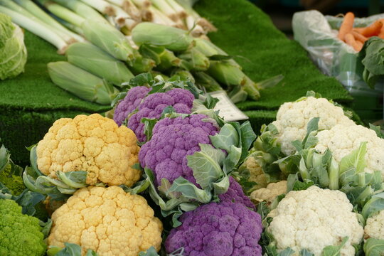 Colored cauliflower on market. Violet cauliflower, orange cauliflower.