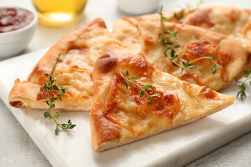 Delicious khachapuri with cheese on white board, closeup
