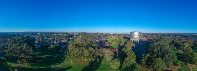 Panoramic Aerial Drone view of Suburban Sydney housing, roof tops, the streets and the parks and...