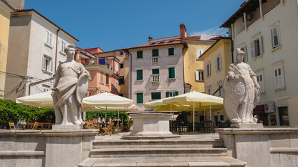 Trg 1 Maja plaza with statues and fountain. 