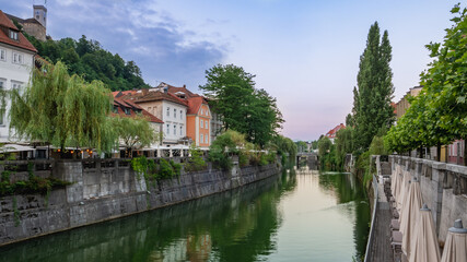 Fototapeta na wymiar Beautiful streets of Ljubljana and river Ljublajnica in Slovenia in the first rays of sun.