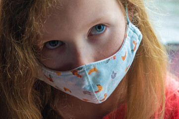 Young Girl Looking Sad in LockDown Wearing a Face Mask for Covid-19 Prevention