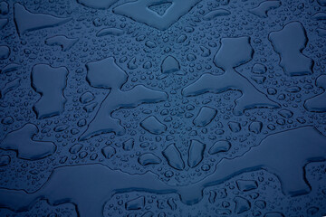 water droplets blue background showing surface tension on a hydrophobic fabric coating