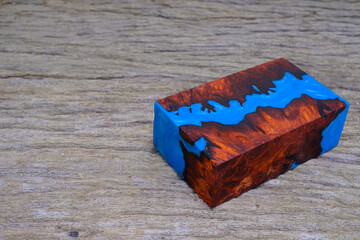 Cube casting epoxy resin with nature burl BURMA PADAUK and maple wood on the old table
