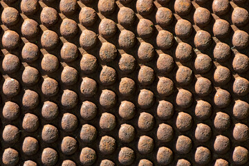 Metal textured background of hemispheres.