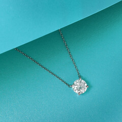 High angle shot of a beautiful diamond necklace on a blue background