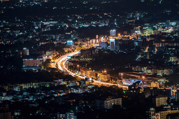 Fototapeta na wymiar long exposure traffic lights from a car,Tourist landmarks doi Suthep viewpoint, Chiang Mai, Thailand, Asia region after sunset, Starlight from the city at night scape.