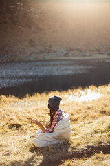 Traveler Woman Hiking in the Mountains With Cup of Coffee Near the Lake