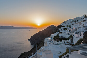 White top of buildings in Santorini, Greece with blue sky in a sunny warm day in July 2021.