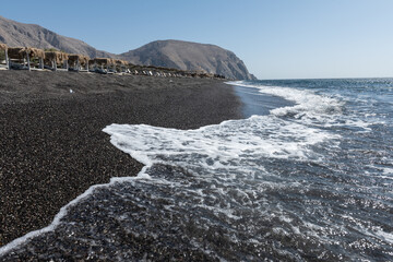 empty Black Sand beach in Santorini Greece early morning 