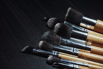Close up of make up brush with black background.