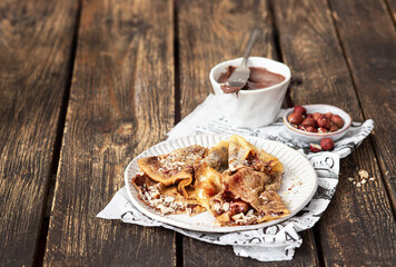 Homemade crepes, tasty with chocolate and nuts.