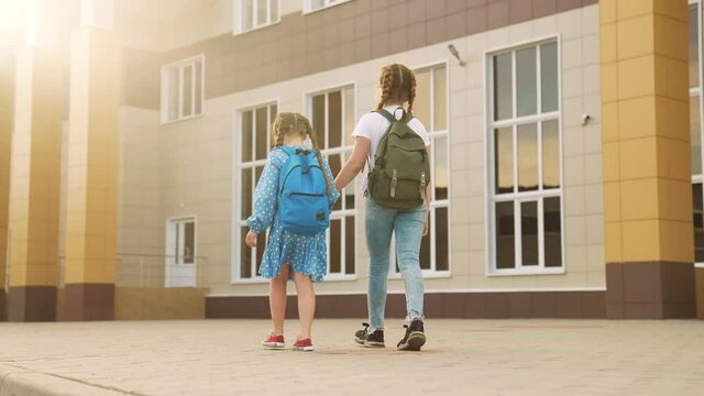back to school. kids a walk to school for lesson. education training support concept. child walk to school with a backpack. kids rush to school. family lifestyle day. group kids with backpacks