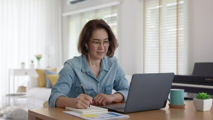 Asia adult people older lady remote distance work sit on desk at home smile happy watch SME owner live meeting class on MBA self tutor webcam webinar for reskill upskill job in web digital tablet. - Powered by Adobe