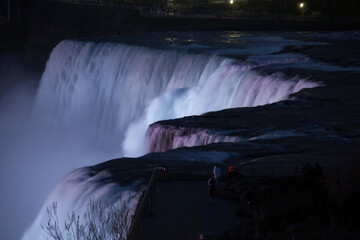 Niagara Falls at night under colored lights