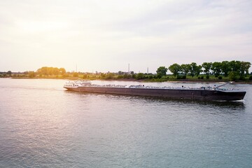Long barge on the river, sunset