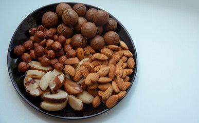 different types useful nuts laid out on a plate 