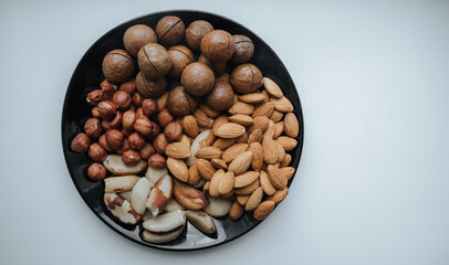 different types useful nuts laid out on a plate 