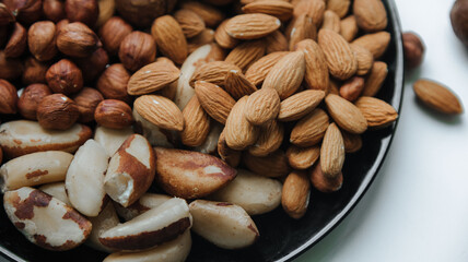 different types useful nuts laid out on a plate 
