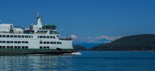 Washington State Ferry underway in the San Juan Islands with Mount Baker in the background.