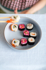sushi on a plate with chopsticks