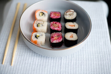 sushi on a plate with chopsticks