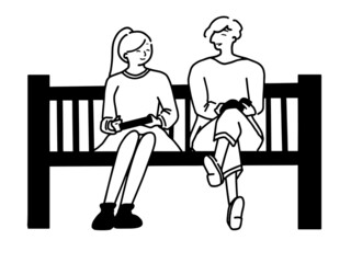 ベンチに座りながら談笑しているカップル