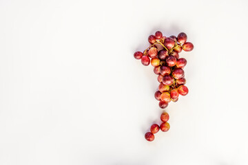 Bunch of claret dessert grapes viewed from the top on plain white background