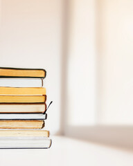 A stack of books by the window, Relaxation with reading books. Home education, reading, literature, study and knowledge concept. Copy space.