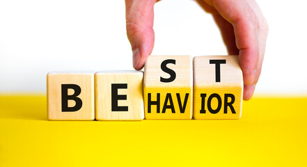 Time to best behavior symbol. Doctor turns wooden cubes with words 'best behavior'. Beautiful yellow table, white background, copy space. Psychology, healthy lifestyle and best behavior concept.