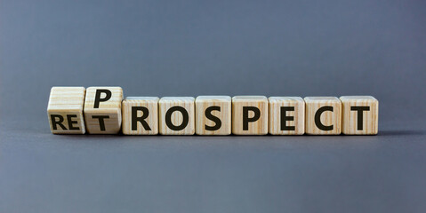 Prospect or retrospect symbol. Turned a cube and changed the word 'retrospect' to 'prospect'. Beautiful grey background. Business and prospect or retrospect concept. Copy space.
