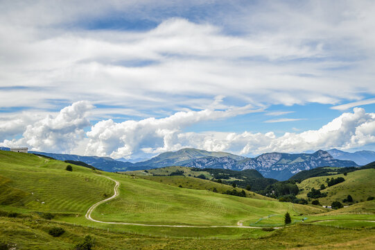 Fantastic landscape with path that climbs towards a hut seen from the Fittanze Di Sega Pass, in Lessinia, near Verona in Italy