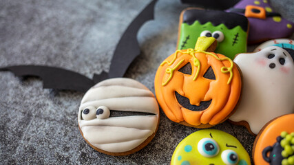 Halloween cookies in the shape of pumpkin, bat, ghost and candy corn with copy space. Happy Halloween! Festive sweets and cookies on the table in the home. Preparation for holiday.