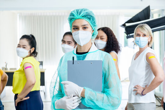 Female Doctor Nurse Wearing A Mask Group Of People After Getting The Covid-19 Vaccine, Composite Shot. A Diverse Group Of Men And Women With Band-aids On Arm After Receiving Immunity Vaccine