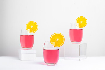 three glasses with pink lady cocktail photogarafado on white background