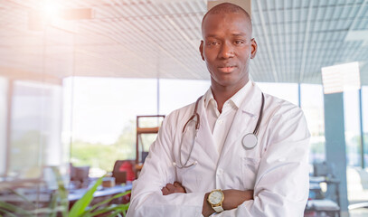 african american doctor is a male doctor on a hospital background.