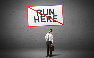 business person holding a traffic sign