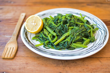 Amaranthus blitum. Vlita Salad (Amaranth Greens) on a plate, on a wooden old table