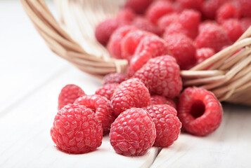 raspberry in a basket on the table in the garden