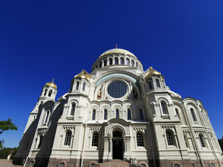 Fototapeta na wymiar Bottom view of the St. Nicholas Cathedral on the background of a cloudless sky, on a summer day in Kronstadt.