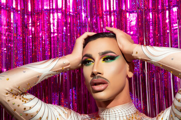 young man makeup drag queen performer with colorful background